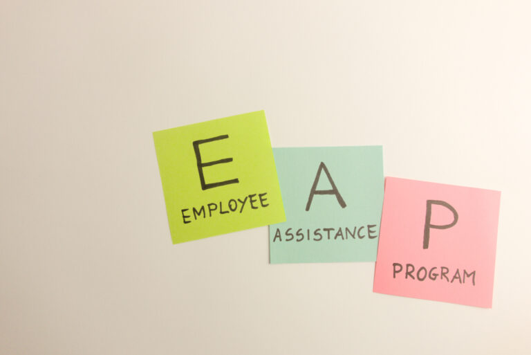 EAP employee assistance program acronym written on sticky notes.