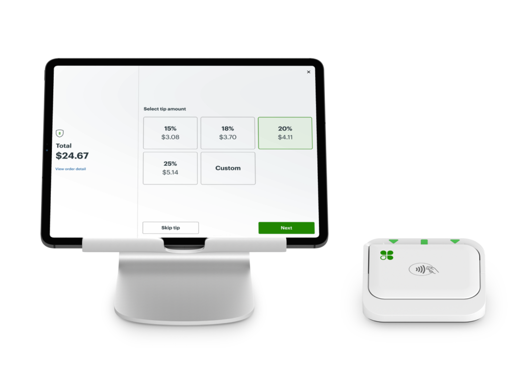 Android tablet displaying Clover POS checkout and mobile card reader resting on a dock to the right.